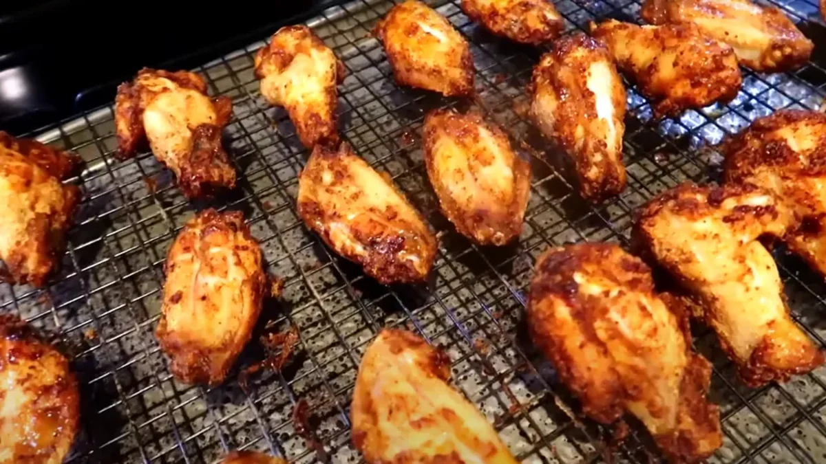 Chicken Wing air fryer Crispy air fryer wings coated in a flavorful glaze, served hot with dipping sauce and garnished with fresh herbs.